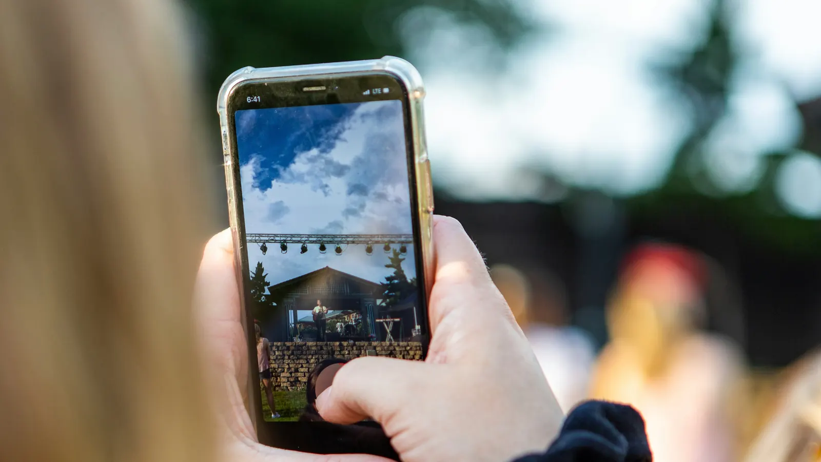 Customer using a smartphone to photograph items for a junk removal quote